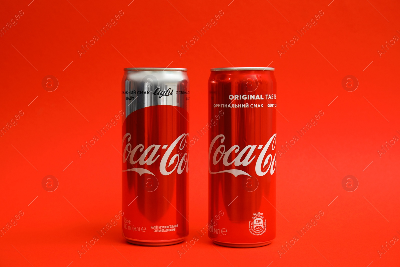 Photo of MYKOLAIV, UKRAINE - NOVEMBER 14, 2018: Coca-Cola cans on color background