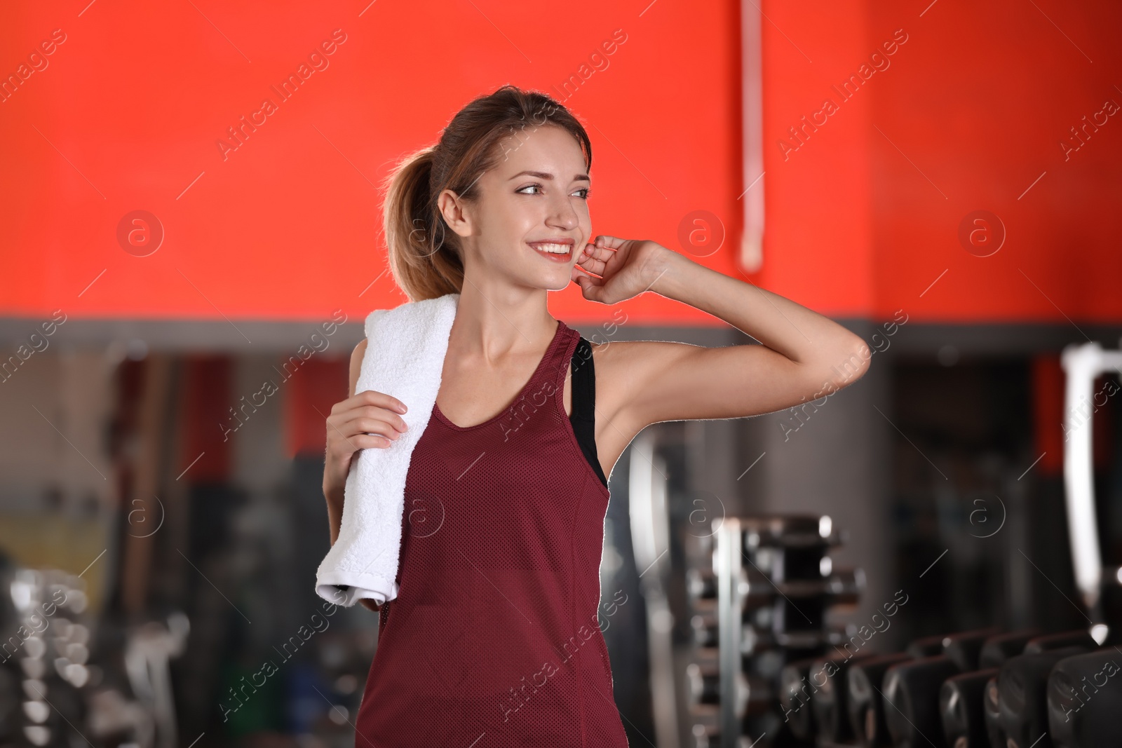 Photo of Beautiful young woman with towel in gym