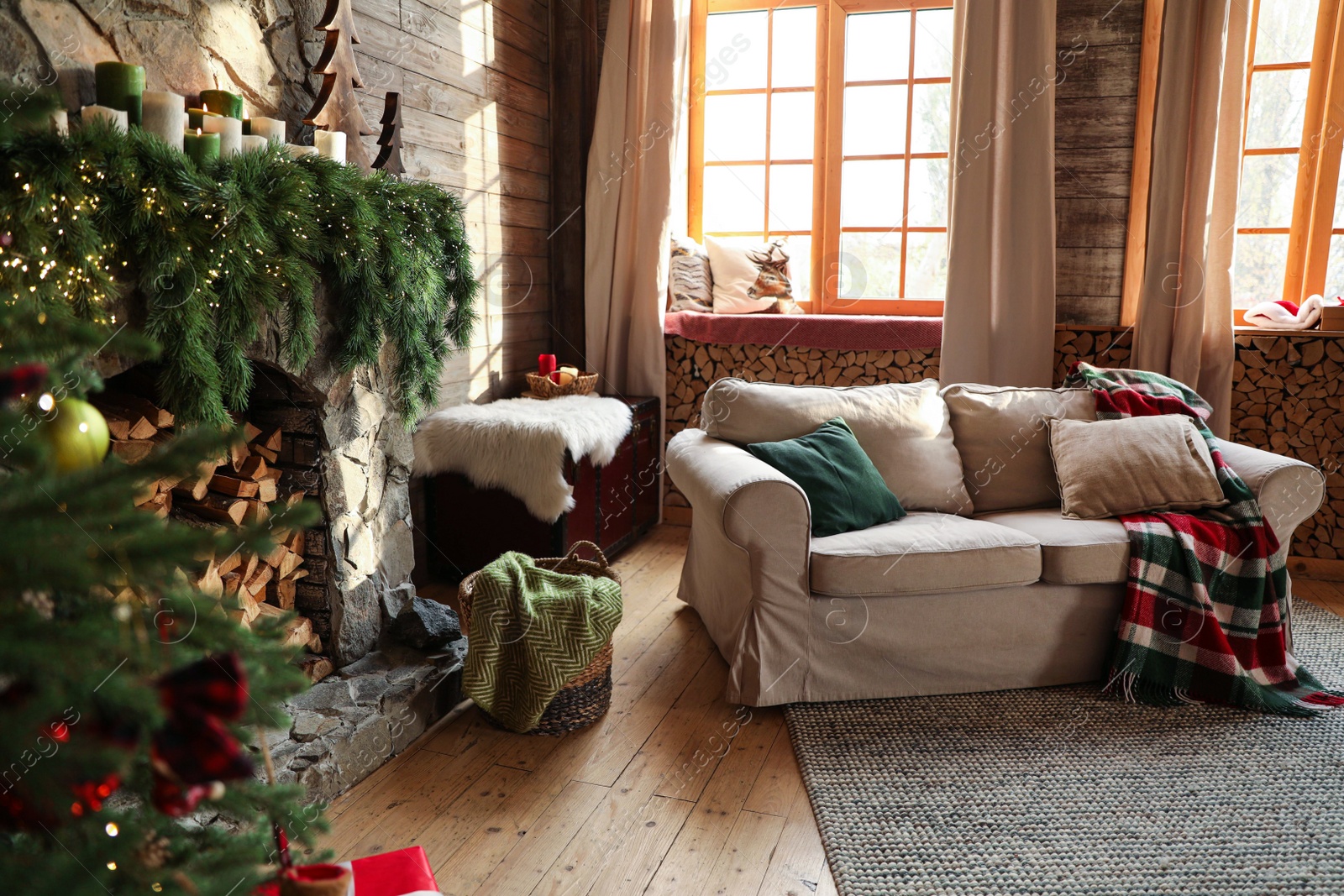 Photo of Festive interior with comfortable sofa and decorated Christmas tree