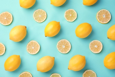 Photo of Flat lay composition with fresh lemons on turquoise background
