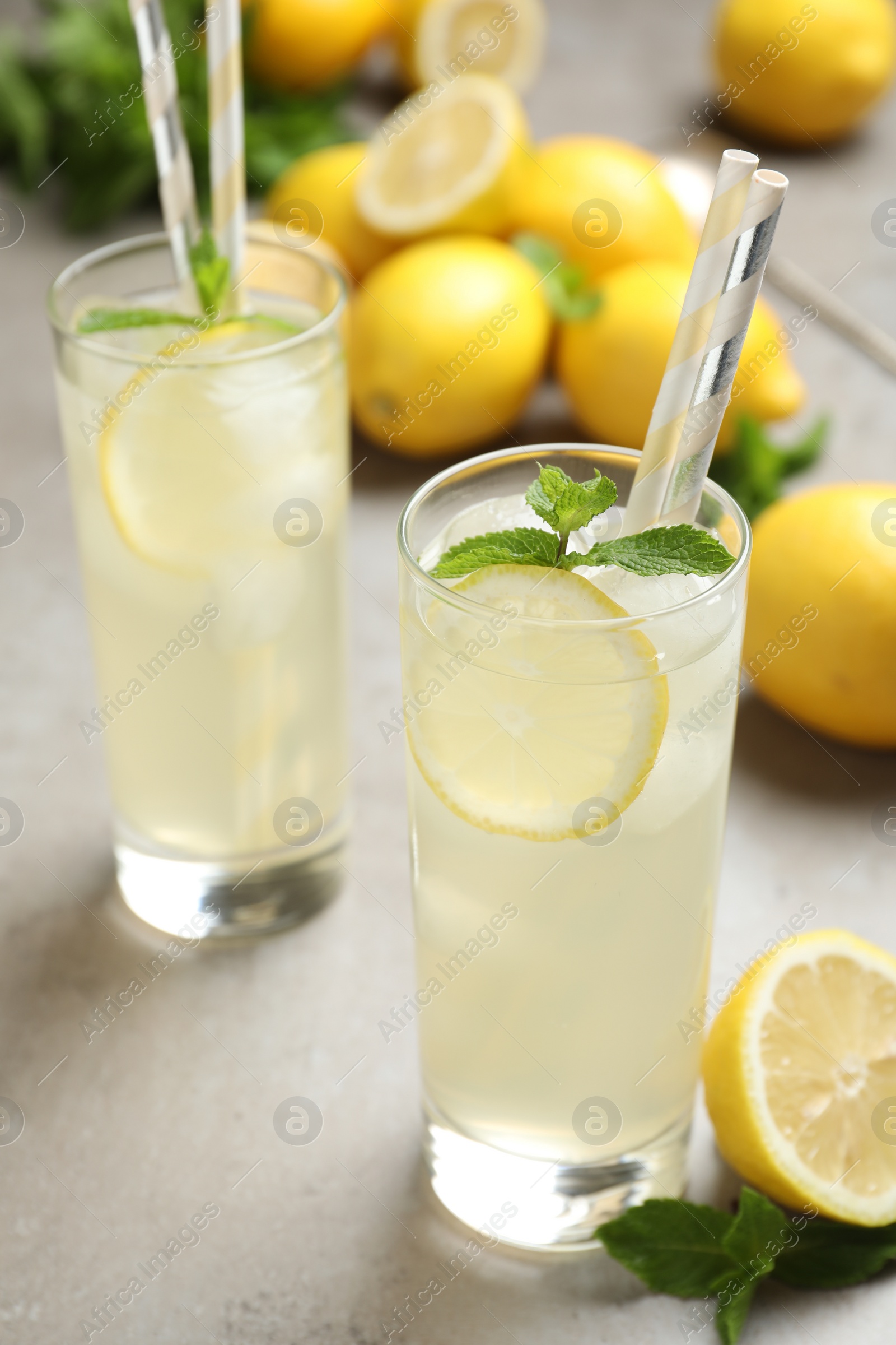 Photo of Natural lemonade with mint on light grey table. Summer refreshing drink