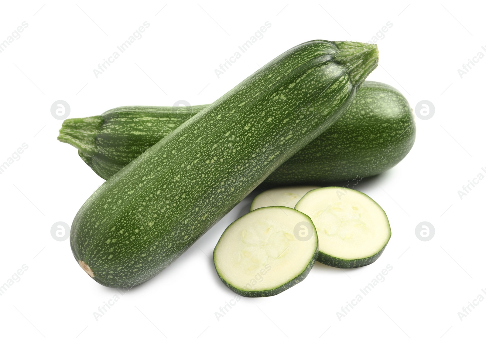 Photo of Whole and cut ripe zucchinis on white background