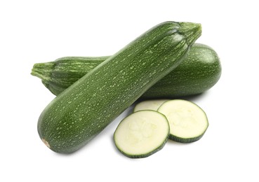 Photo of Whole and cut ripe zucchinis on white background