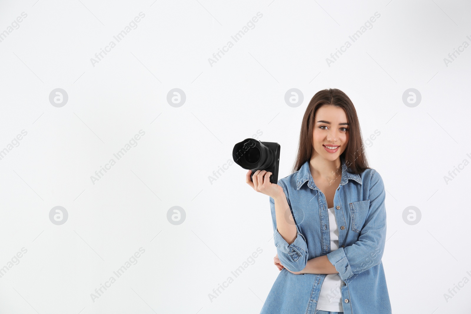 Photo of Female photographer with camera on light background