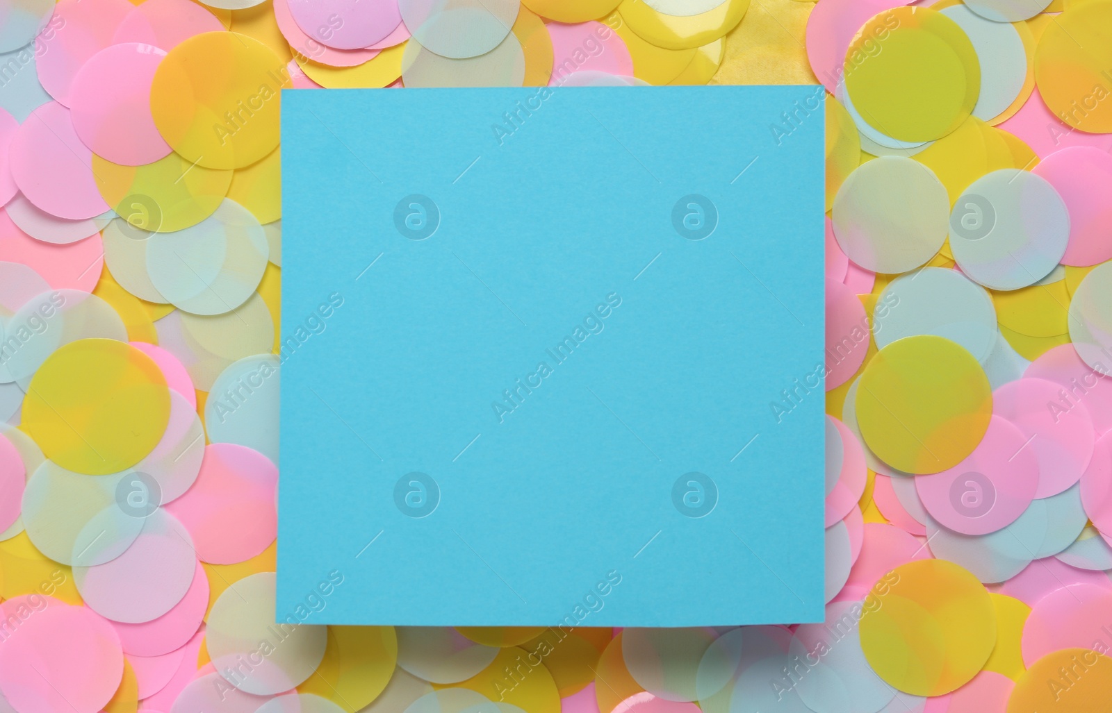 Photo of Card on bright confetti, top view. Space for text