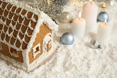 Photo of Beautiful gingerbread house and Christmas decor on snow