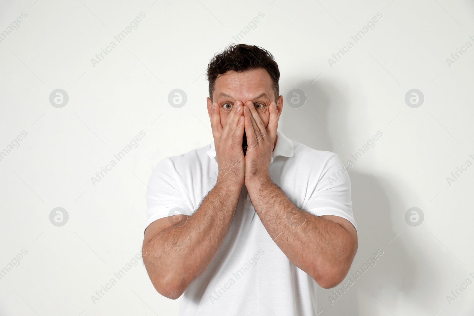 Photo of Portrait of shocked man on white background