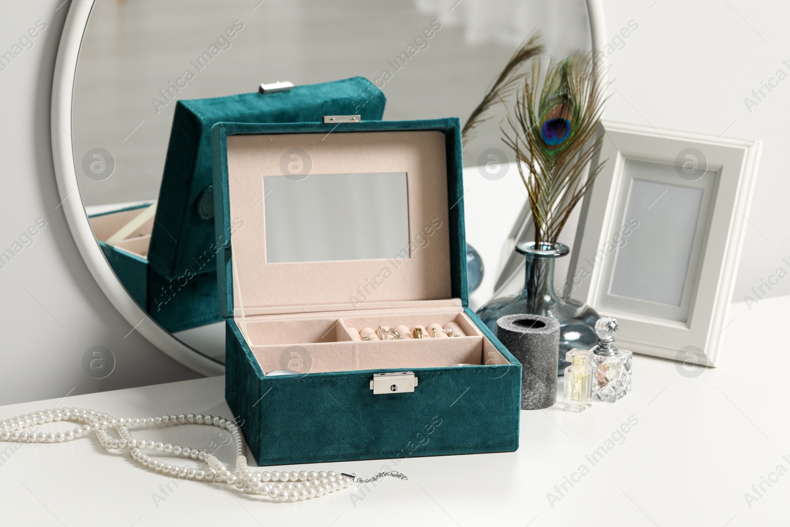 Photo of Jewelry box with many different accessories and decor on white table