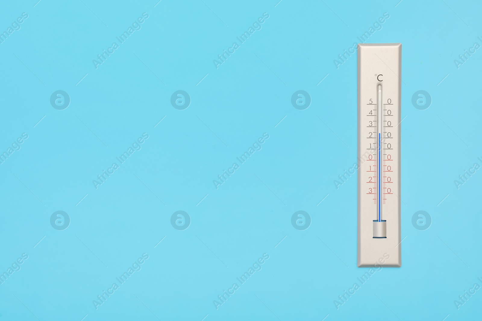 Photo of Weather thermometer on light background, top view. Space for text