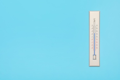 Photo of Weather thermometer on light background, top view. Space for text