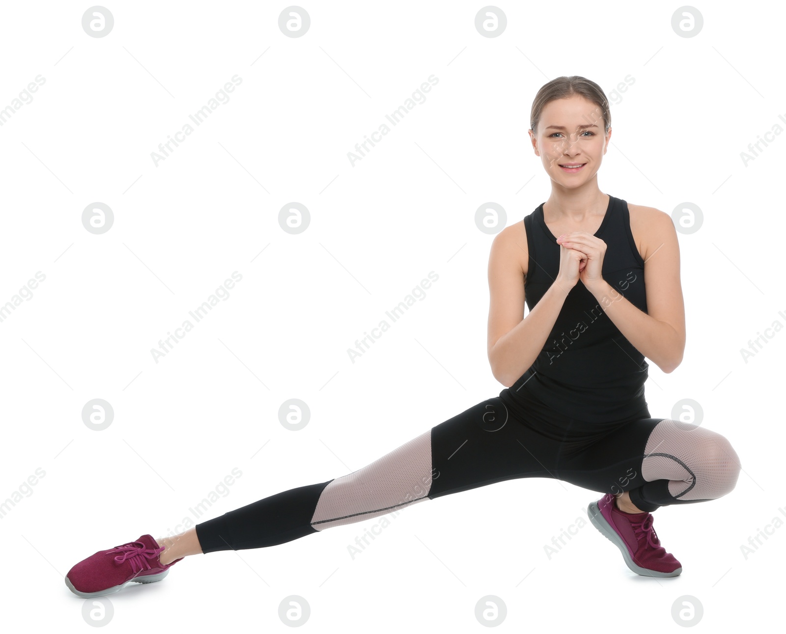 Photo of Young woman doing sports exercises isolated on white. Home fitness