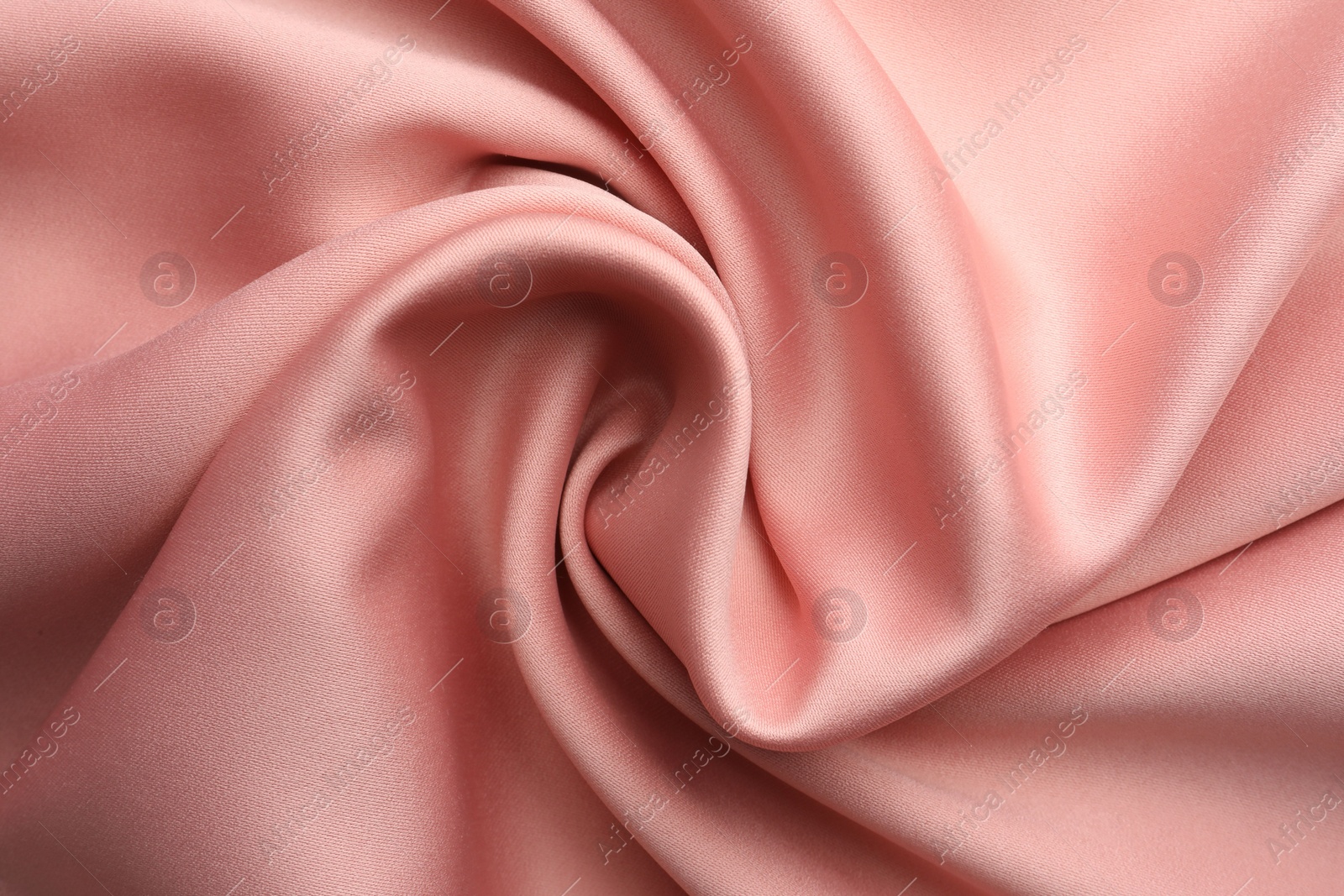 Photo of Crumpled pink silk fabric as background, top view