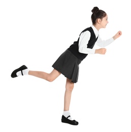 Happy girl in school uniform walking on white background