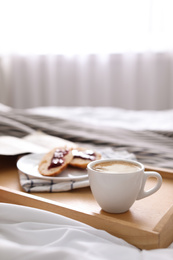 Photo of Morning coffee and sandwiches on tray in bedroom. Space for text