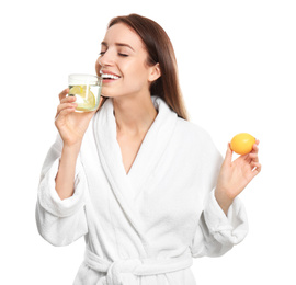 Young woman drinking lemon water on white background