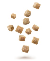 Brown cane sugar cubes falling on white background