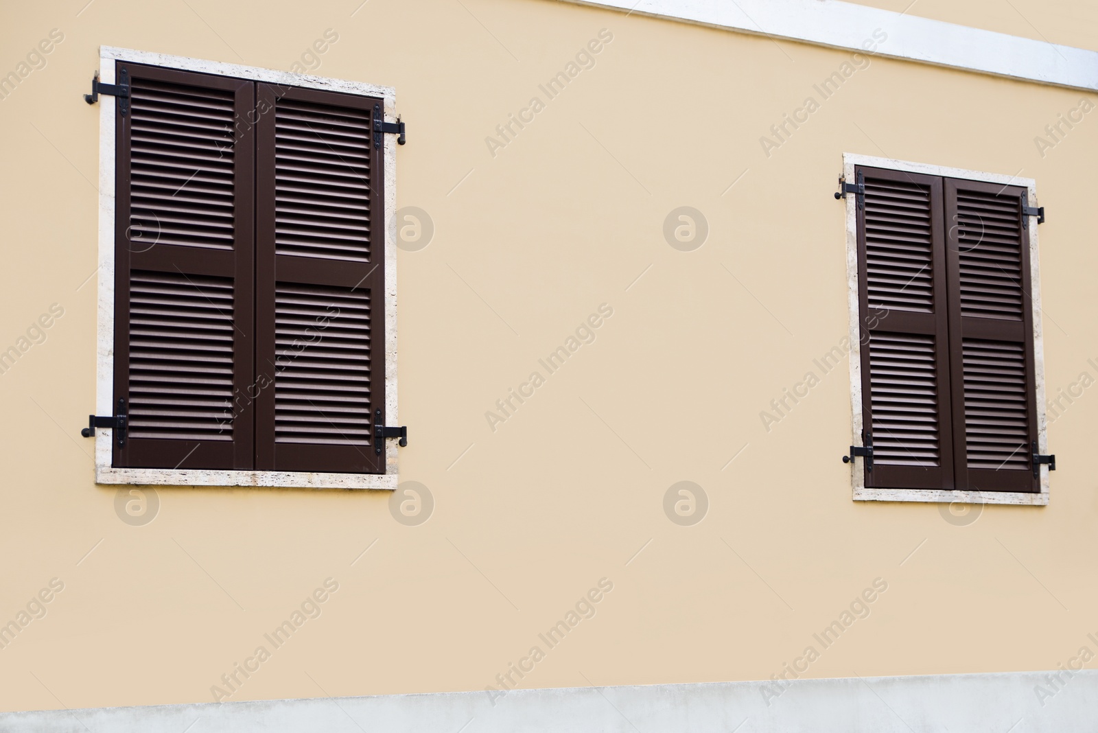 Photo of Beautiful building with windows and wooden shutters