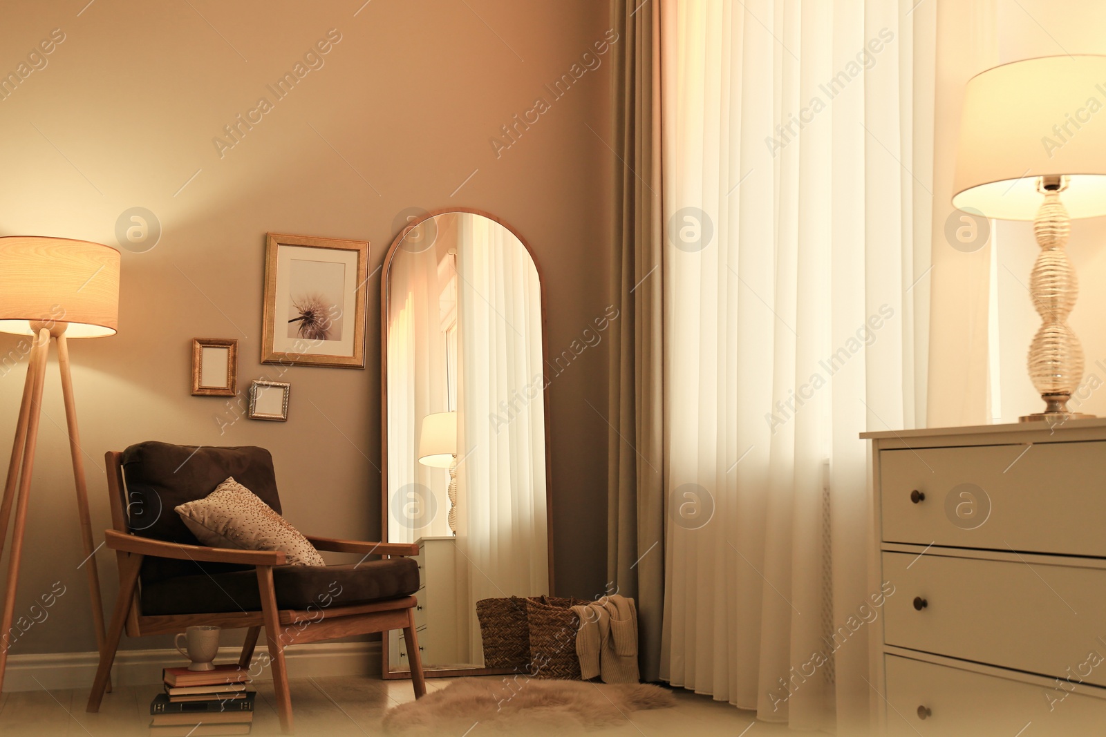 Photo of Stylish room interior with large mirror and comfortable armchair near window