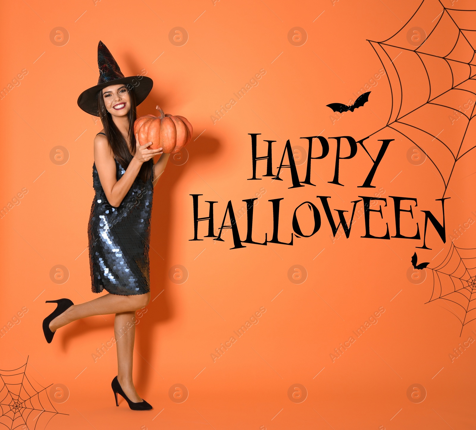 Image of Happy Halloween greeting card design. Beautiful woman wearing witch costume with pumpkin on orange background
