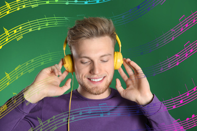 Image of Handsome young man listening to music with headphones on green background. Bright notes illustration