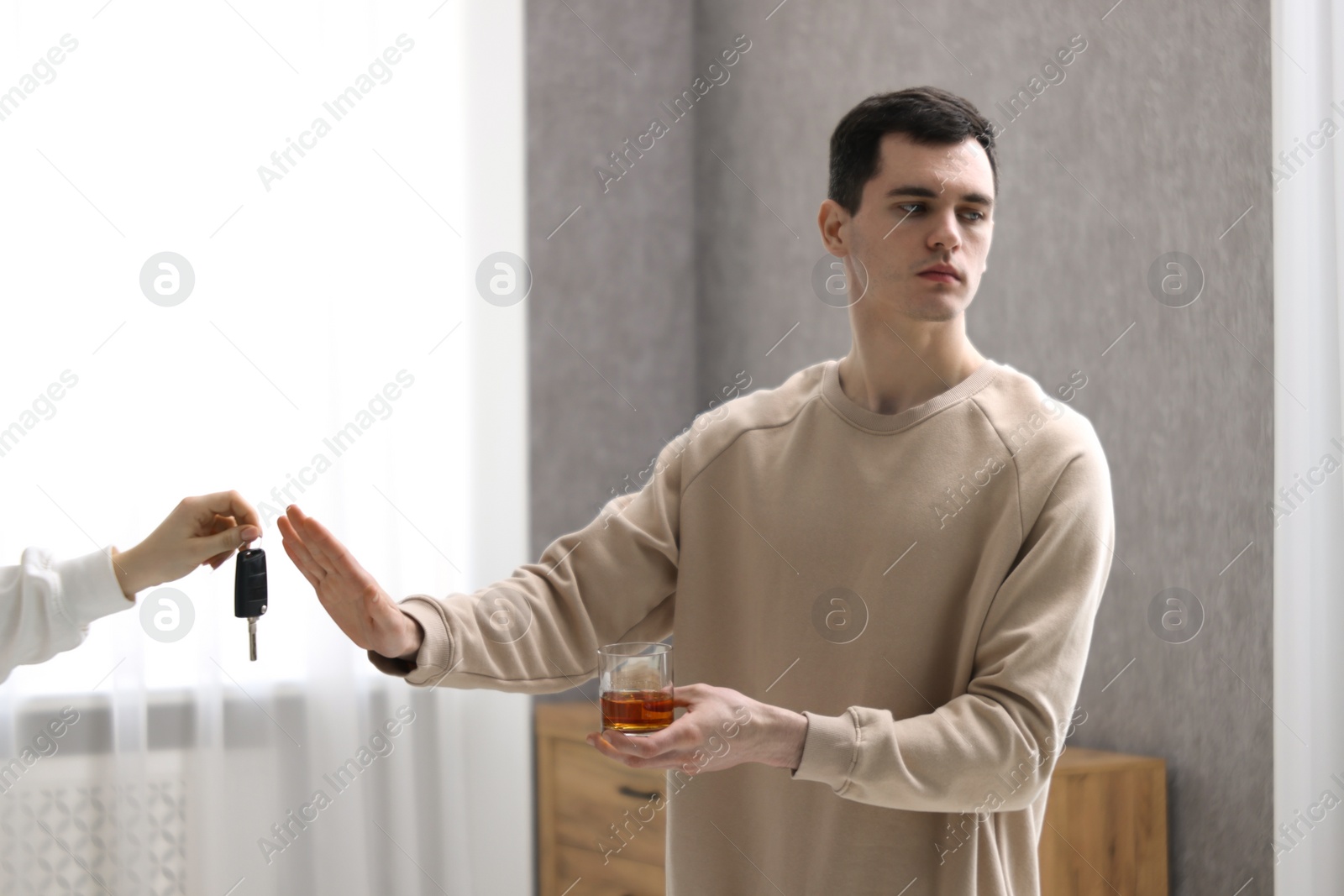 Photo of Drunk man refusing drive car while woman suggesting him keys, closeup. Don't drink and drive concept