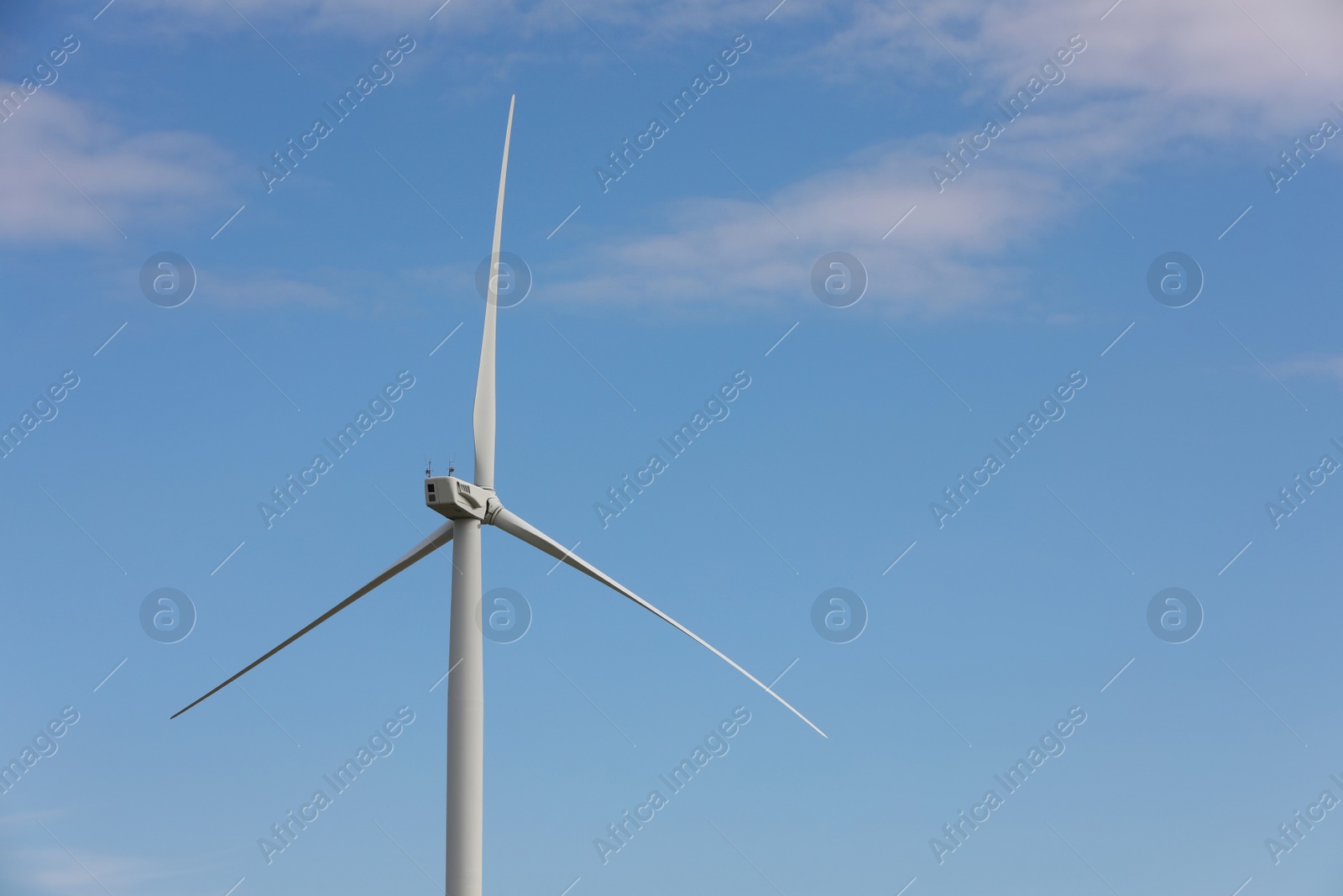 Photo of Wind turbine against beautiful blue sky. Alternative energy source