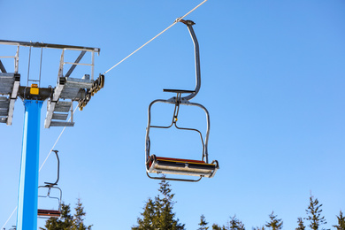 Photo of Empty chairlift at mountain ski resort. Winter vacation