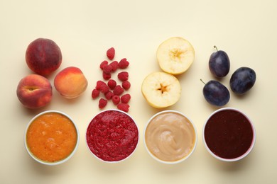 Different puree in bowls and fresh ingredients on beige background, flat lay