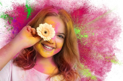 Holi festival celebration. Happy teen girl covered with colorful powder dyes holding flower on white background