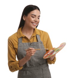 Young woman drawing with brush on white background