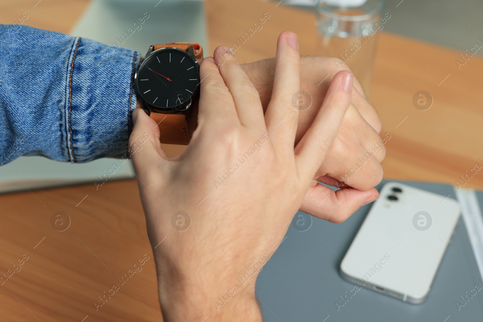 Photo of Man checking time in room, closeup. Being late