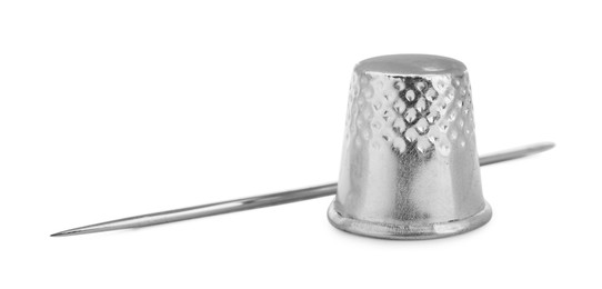 Photo of Sewing thimble and needle isolated on white