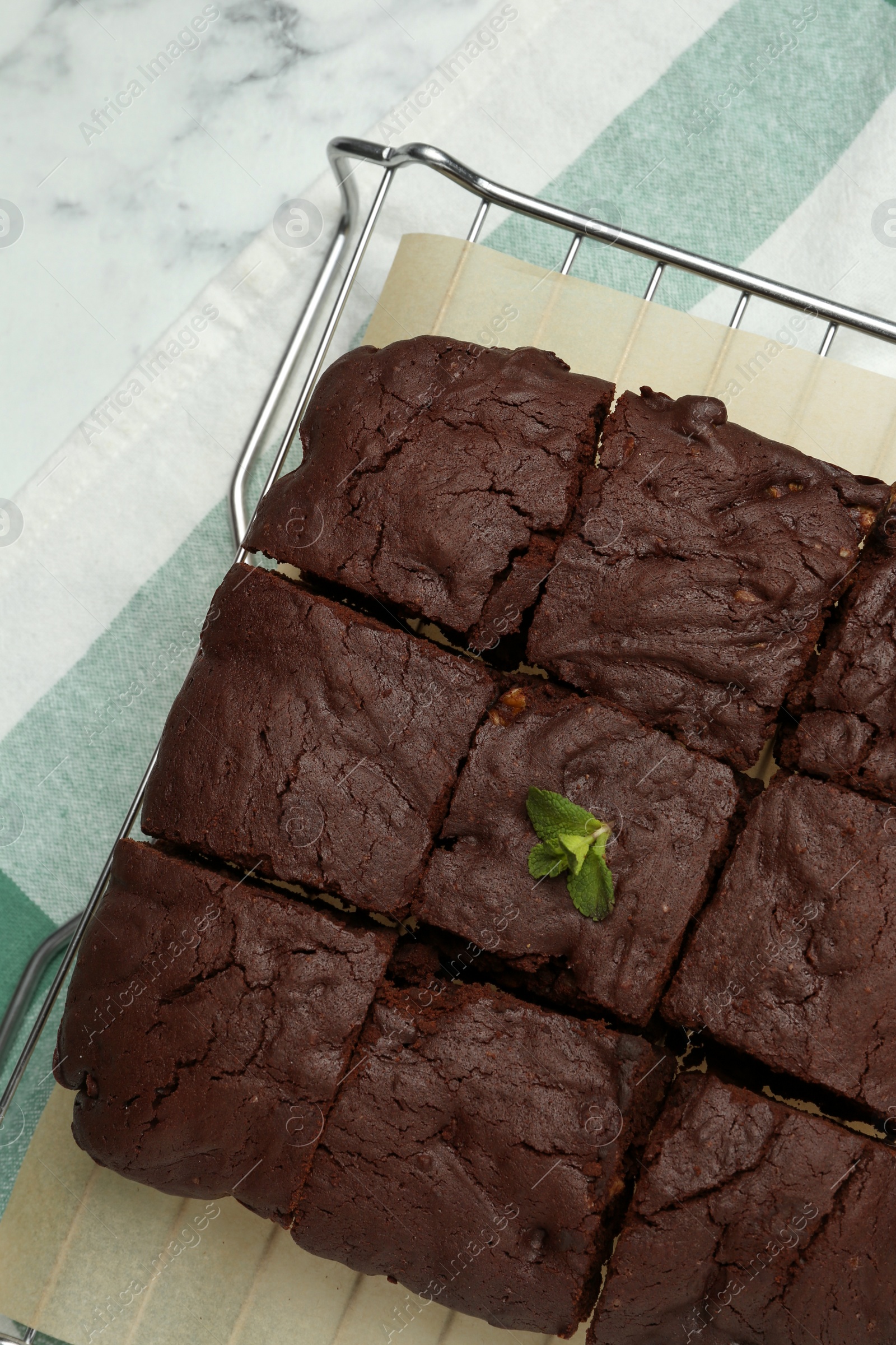 Photo of Delicious freshly baked brownies on white marble table, top view