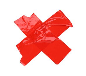 Crossed pieces of red adhesive tape on white background, top view