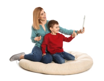 Mother and her son using video chat on tablet, white background