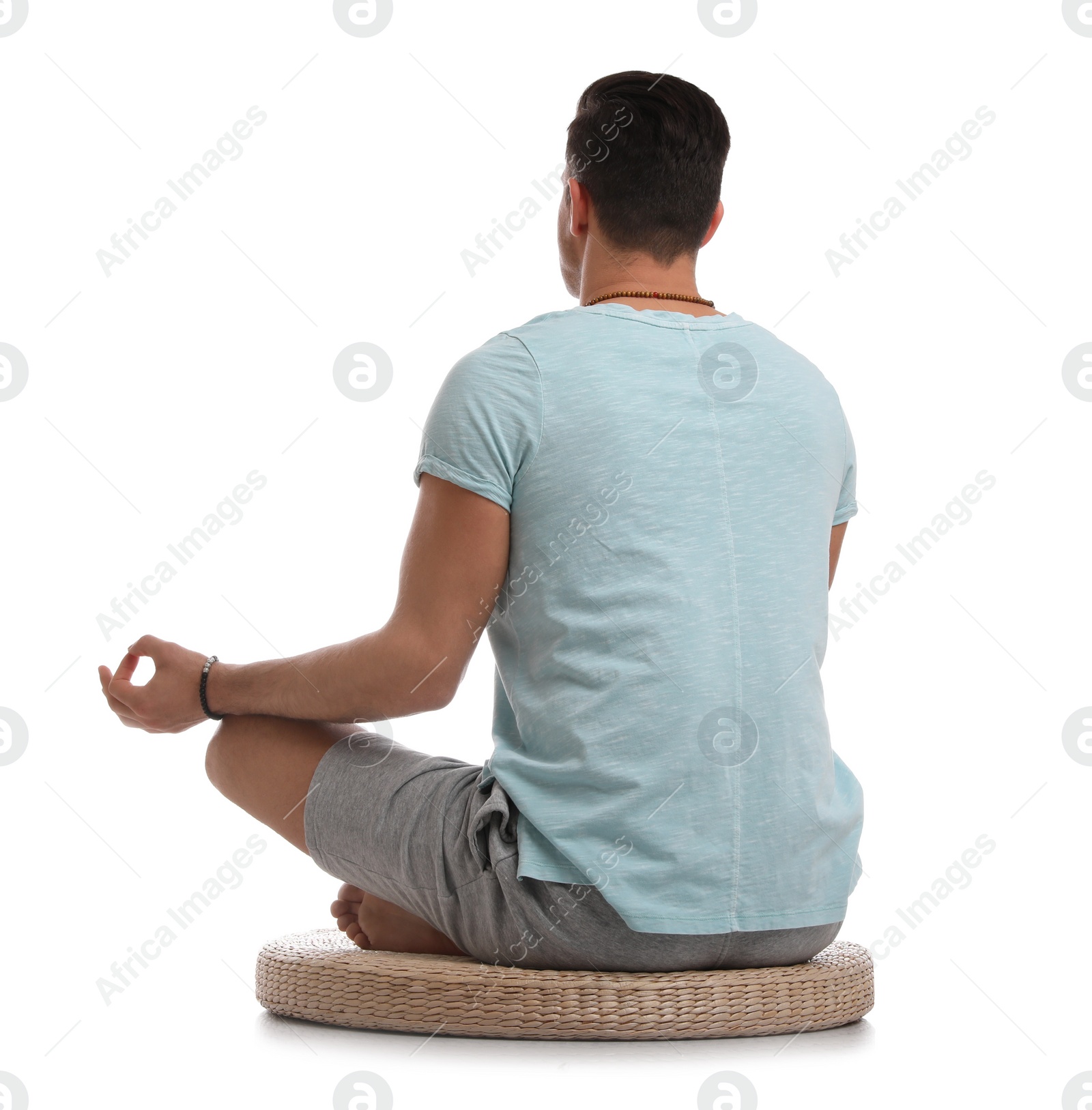 Photo of Man meditating on white background, back view