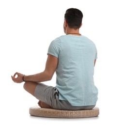 Man meditating on white background, back view