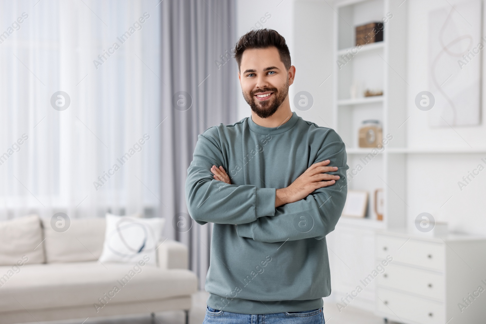 Photo of Happy man in stylish sweater at home