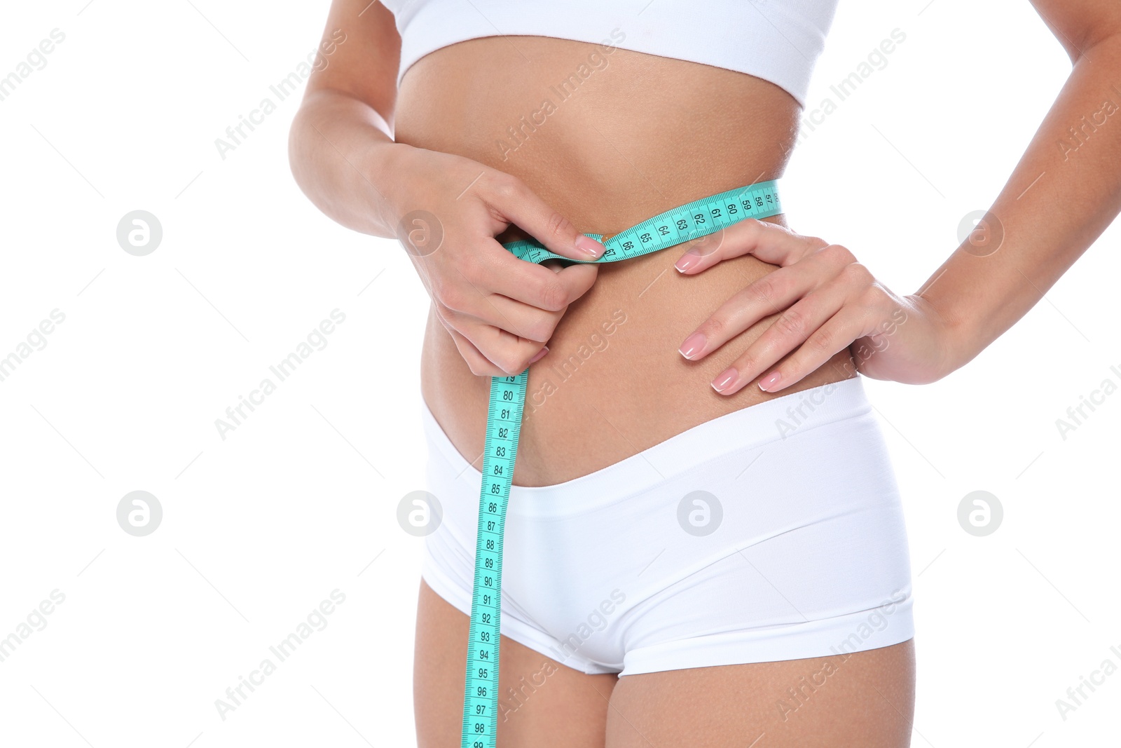 Photo of Slim woman measuring her waist on white background, closeup. Weight loss