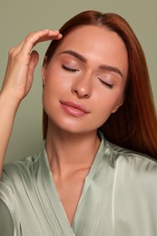 Photo of Portrait of beautiful young woman on green background