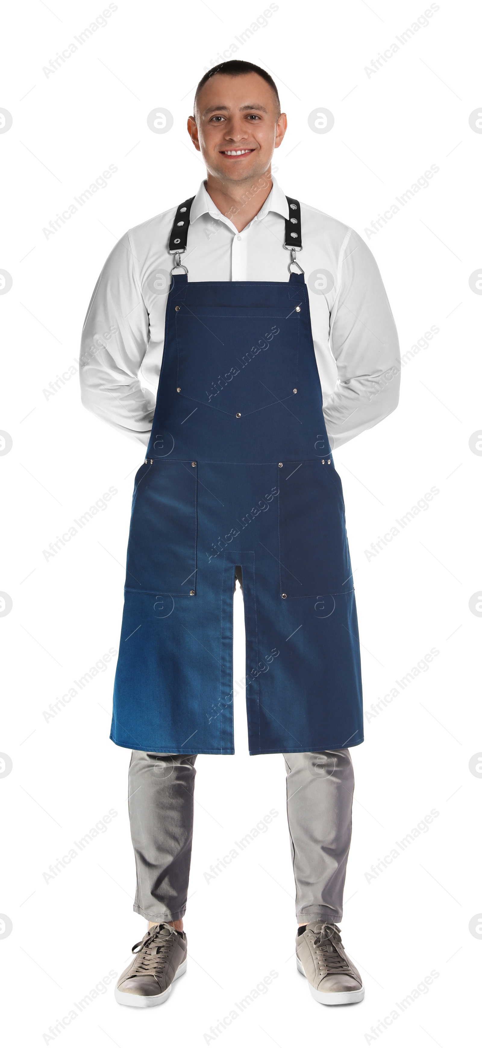 Photo of Full length portrait of happy young waiter in uniform on white background