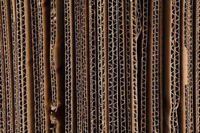 Photo of Sheets of brown corrugated cardboard as background, closeup