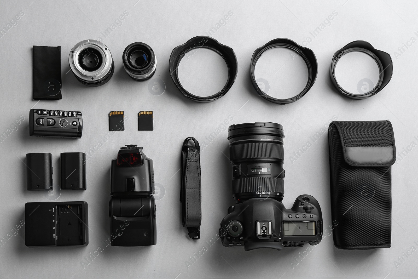 Photo of Flat lay composition with professional photographer equipment on light background