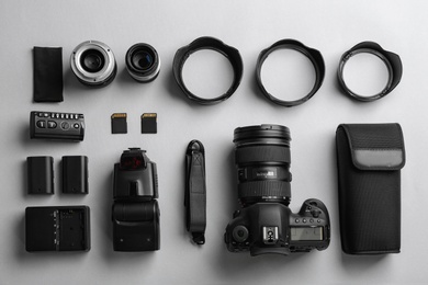 Flat lay composition with professional photographer equipment on light background