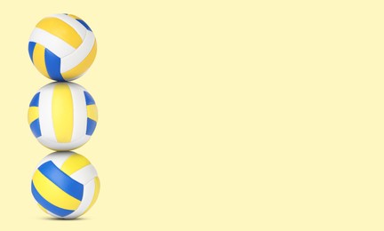 Image of Stack of volleyball balls on pale light yellow background. Space for text