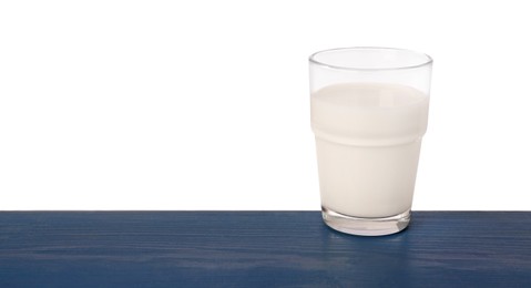 Photo of One glass of tasty milk on blue wooden table against white background