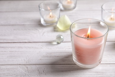 Photo of Beautiful composition with burning wax candle on table
