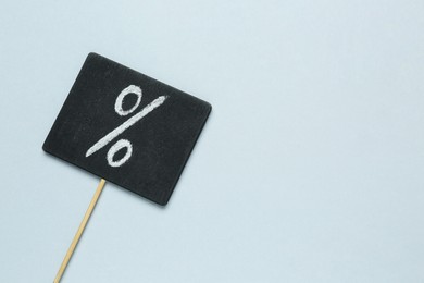 Photo of Sign with percent symbol on grey background, top view. Space for text