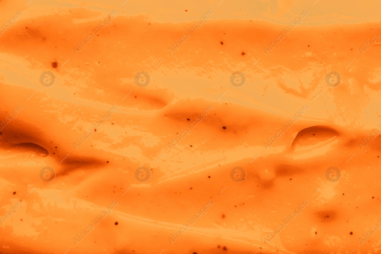 Image of Texture of body cream as background, closeup. Toned in orange