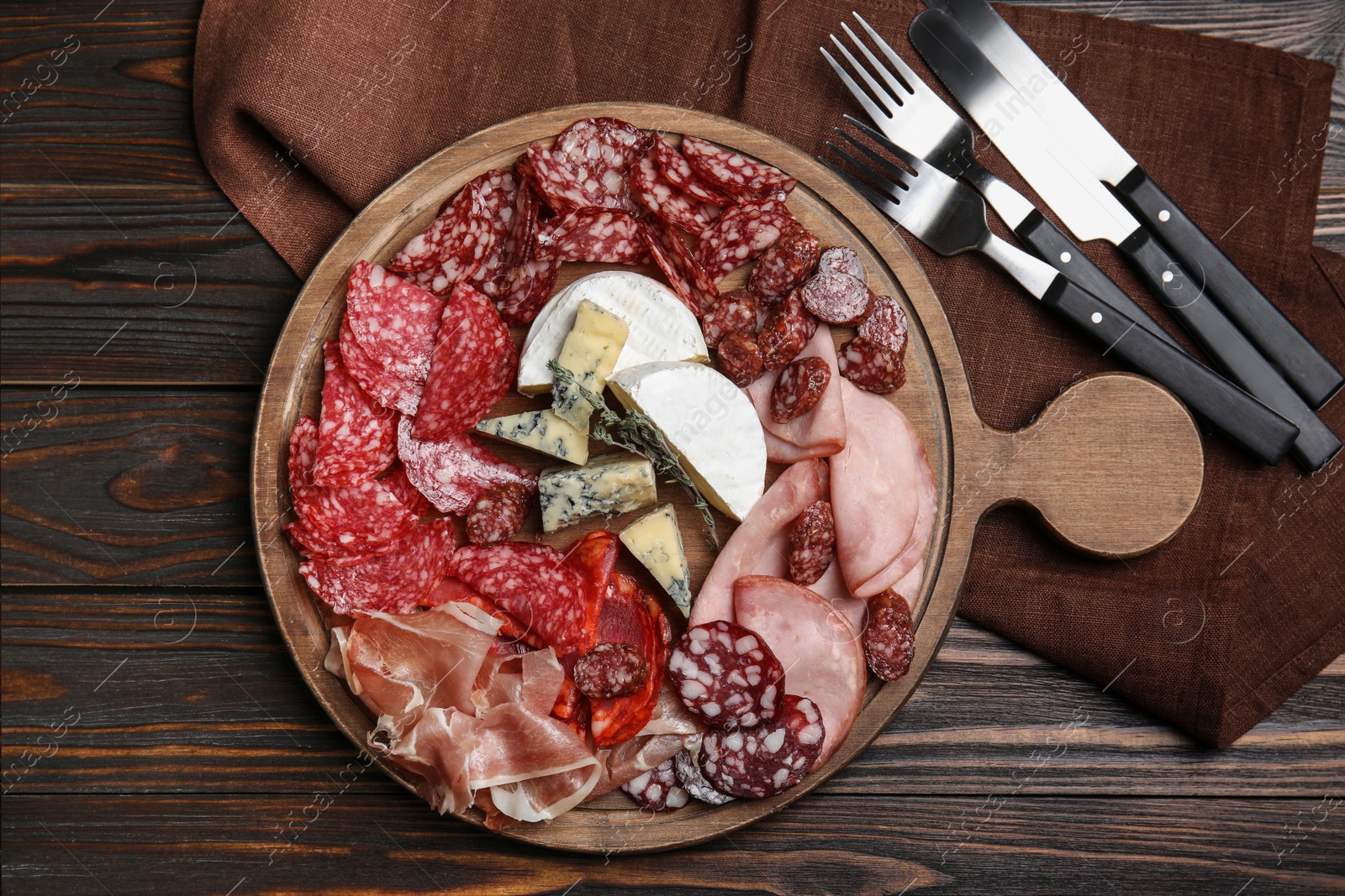Photo of Tasty ham and other delicacies served on wooden table, flat lay